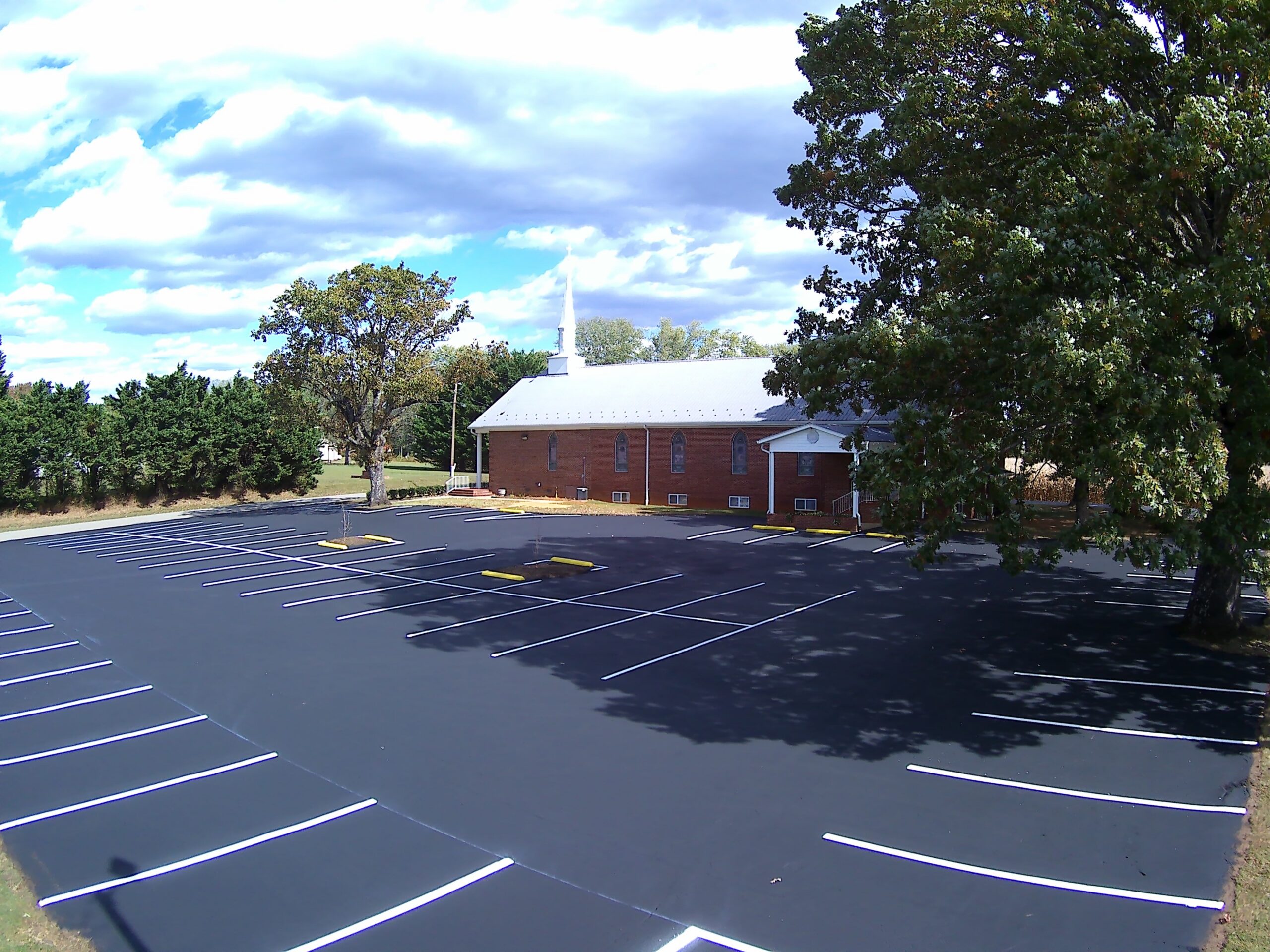 Drone view of freshly sealcoated church parking lot — Northwestern NC.