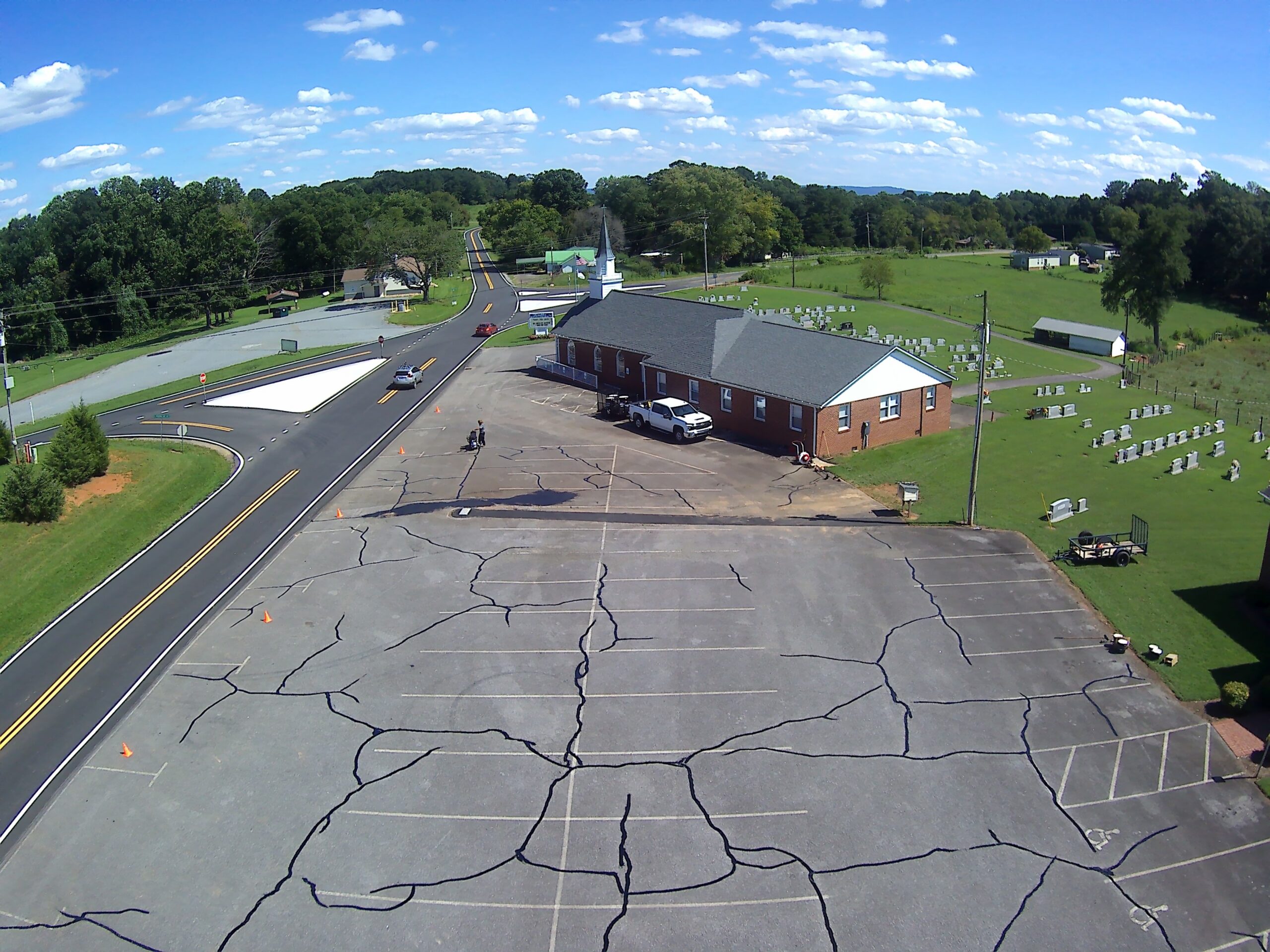 Church parking lot before crack repair and sealcoating